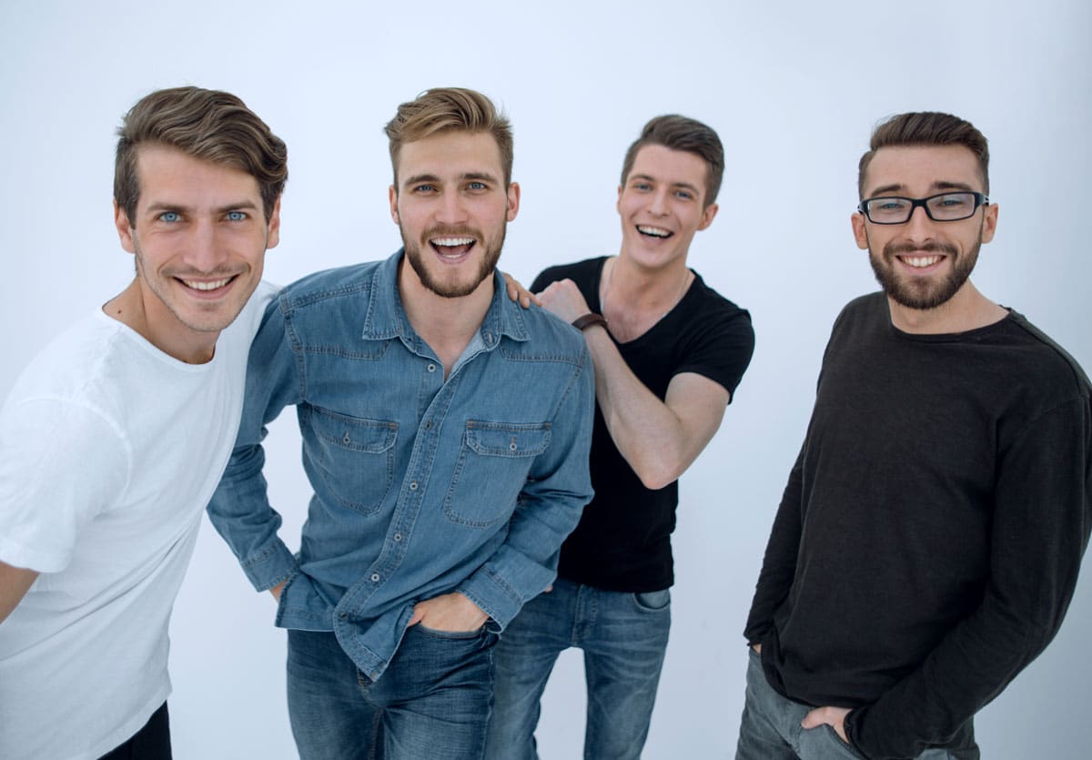 Group of four young happy guys
