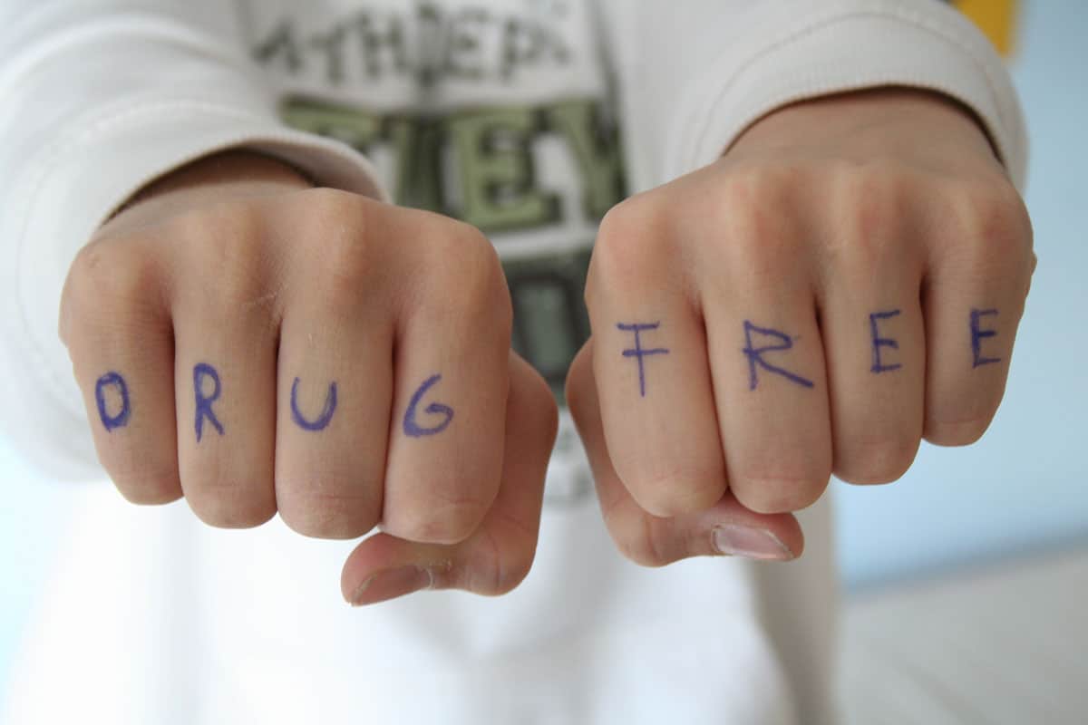 Two closed fists with "Drug Free" written on the outside of the fingers. 4U Health's Urine & Saliva Drug Test Kits can be used in a drug-free household program.