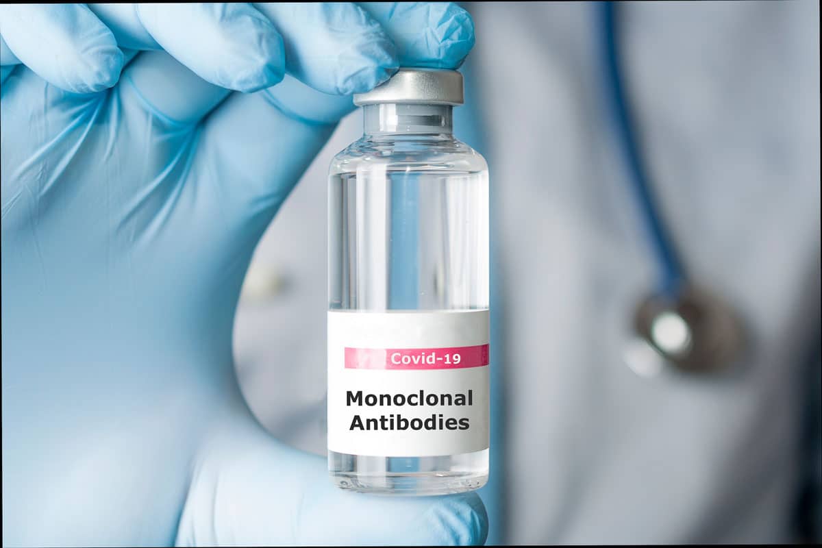 Doctor holds a vial of covid-19 coronavirus monoclonal antibodies