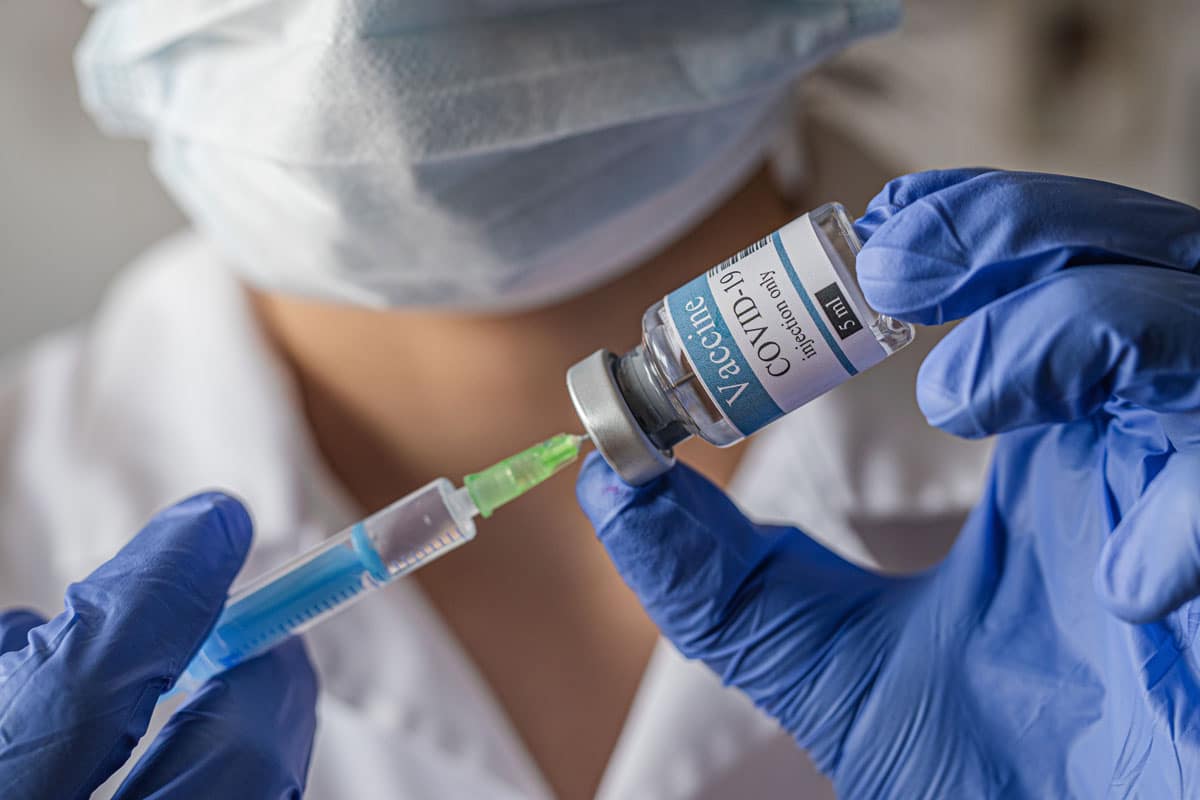 Doctor holding covid-19 coronavirus vaccine shot